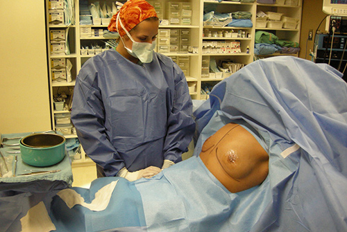 Why do we do breast augmentation sitting up?