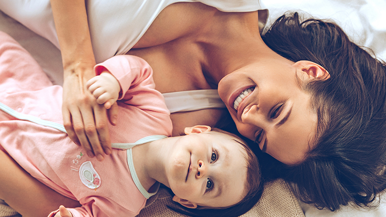 woman lounging with her baby