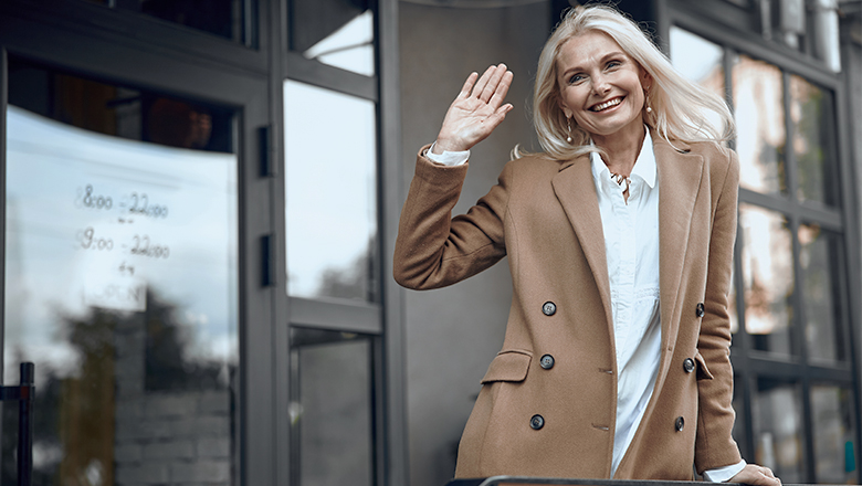 photo of a smiling woman waving