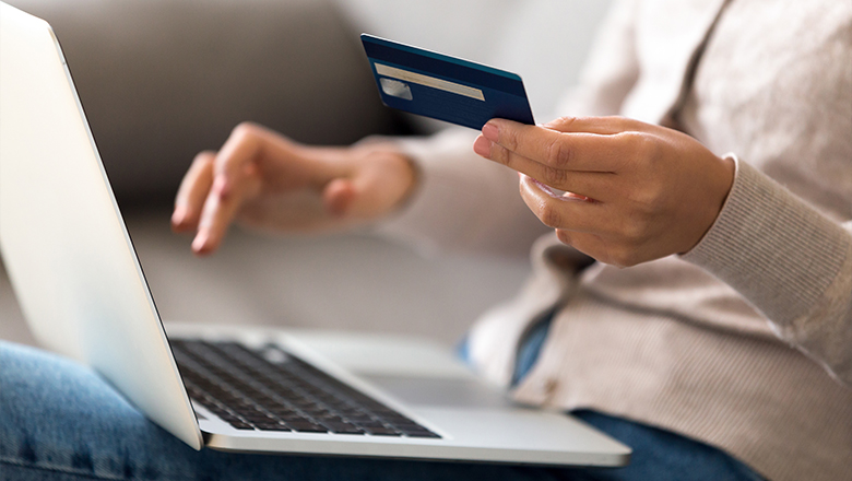 photo of a woman with a credit card and laptop