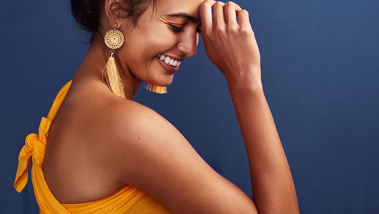photo of a smiling woman, focused on her bare shoulder